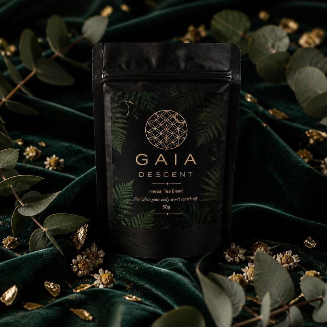 GAIA DESCENT tea package on a dark green fabric background with leaves and flowers.