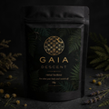 Black tea packaging with 'Gaia Descent' branding on a dark background with herbs.